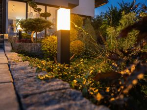 How does landscape lighting improve home security?